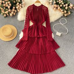 Step into a world of bohemian elegance with this stunning burgundy pleated lace dress. The intricate lace detailing on the sleeves and neckline evokes a romantic and ethereal feel, perfect for any free-spirited fashionista. The high neckline and long sleeves provide a sophisticated silhouette, while the delicate lace offers a sheer, tantalizing glimpse of skin beneath.At the waist, a gathered detail creates a flattering shape before the dress cascades into a series of pleated tiers, each one dan Elegant Fitted Chiffon Lace Dress, Elegant Fall Maxi Dress With Lace Trim, Elegant Lace Maxi Dress With Long Sleeves, Formal Fall Lace Maxi Dress, Elegant Winter Dresses With Lace Trim, Formal Lace Maxi Dress For Fall, Fall Wedding Dress With Pleated Details, Fall Wedding Pleated Dress, Elegant Winter Lace Dress