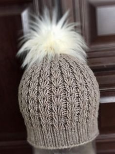 a knitted hat with white fur on top