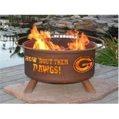 a large metal fire pit sitting on top of a wooden platform