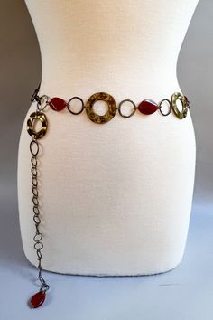 Add a touch of boho glam with our Amber Xena Belt! This metal chain belt features natural stones and a secure lobster claw closure. Please note that color and texture may vary due to the use of natural materials. Perfect for adding a unique and playful touch to any outfit. Length: 46" Bohemian Metal Chain Belt For Party, Adjustable Bohemian Chain Belt For Party, Bohemian Adjustable Chain Belt As A Gift, Bohemian Style Adjustable Metal Chain Belt, Bohemian Adjustable Chain Belt For Festivals, Adjustable Bohemian Chain Belt For Festivals, Adjustable Metal Waist Chain Belt, Adjustable Gold Bohemian Chain Belt, Adjustable Metal Chain Belt