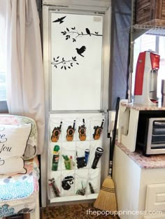 a kitchen area with a refrigerator, microwave and other items on the counter in front of it