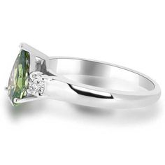 Product Description This beautiful three-stone engagement ring is set with a VS1 clarity pear-cut green diamond and round white accent diamonds. The ring is made from 18k white gold. Product Details Main Stone: Pear-Cut Green Diamond Color: Fancy Green - Irradiated Clarity: VS1 clarity (Near Flawless, Natural) Weight & Size: 1.18ct, 9mm x 6mm Total Ct Weight: 1.39ct Side Stones: Fine Diamonds (0.21ct) Side Stone Clarity: VS2-SI1 clarity (Clean, Natural) Side Stone Color: F color (Colorless, Modern Green Diamond Wedding Ring, Trillion Cut Emerald Ring In White Gold, Trillion Cut Emerald Ring With Diamond In Prong Setting, Green Trillion Cut Diamond Ring, Green Diamond Solitaire Ring, Elegant Green Trillion Cut Diamond Ring, Trillion Cut White Gold Emerald Ring With Diamond, Green Diamond Ring Pear-shaped, Green Marquise Cut Rings With Brilliant Detail