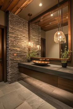 a bathroom with a stone wall and wooden ceiling, along with a bowl on the counter