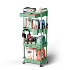 a green cart with books, headphones and other items on it's wheels