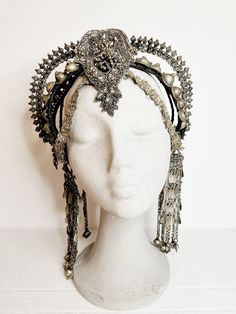 Indulge your inner goddess with this exquisite Afghan tribal headpiece, a bold statement piece that exudes power and elegance. Handcrafted with a mix of intricate beads, embroideries, vintage rhinestones, and luxurious vegan leather, this stunning headpiece is a true work of art. Whether you're heading to a festival, a stage show, or a special performance, this headpiece is designed to make you stand out from the crowd with its captivating glamour and tribal allure. Crafted for comfort and light Adjustable Tall Crown Headpieces For Festivals, Adjustable Festival Headband, Adjustable Teardrop Crown Headpiece For Festivals, Adjustable Crown Headpieces For Festival, Adjustable Crown Headpiece For Festivals, Adjustable Rhinestone Headpiece For Festival, Adjustable Rhinestone Festival Headpiece, Adjustable Festival Headpiece With Rhinestones, Traditional Headband For Party