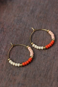 "Lovely beaded earrings with glass seed beads (bright orange,light \"salmon\" and \"ivory\" colors), tiny gold plated metal beads and gold tone stainless steel round hoop earrings. Earring hooks are from nickel free and lead free metal. Perfect jewelry for everyday wear or a great gift for someone special! Diameter of hoops is 25 mm Other earrings of my shop you can see here: https://www.etsy.com/shop/NaTavelli?section_id=13757927 Thanks for visit." Summer Tiny Beads Small Hoop Earrings, Trendy Summer Small Hoop Beaded Earrings, Summer Small Hoop Beaded Earrings, Minimalist Handmade Beaded Hoop Earrings, Orange Beaded Hoop Earrings As A Gift, Orange Hoop Beaded Earrings As Gift, Orange Beaded Hoop Earrings For Gift, Orange Beaded Earrings With Tiny Round Beads, Orange Small Hoop Earrings With Ear Wire