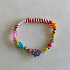 Colorful handmade fruity bracelet made with stretchy elastic cord for an easy fit! Every bracelet is unique and filled with fun and eclectic bead shapes and sizes. Colorful Adjustable Playful Friendship Bracelets, Fun Beaded Stretch Bracelet For Summer, Colorful Beaded Playful Friendship Bracelets, Adjustable Rainbow Beaded Bracelets Playful Style, Adjustable Rainbow Beaded Bracelets In Playful Style, Playful Adjustable Beaded Bracelets With Colorful Beads, Adjustable Rainbow Beaded Bracelets, Playful Style, Fun Pink Stretch Bracelet With Colorful Beads, Handmade Multicolor Flexible Stretch Bracelet