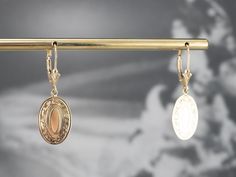 These beautiful earrings were handcrafted by our studio, using pieces of antique cufflinks! The handsome, sophisticated dangles are a beautiful yellow 14k gold that is chased with beautiful scrolling details! These date to the Victorian era! We've created bails and hung them on leverbacks of 14K yellow gold. Metal: 14K Yellow Gold Earrings Length: 32 mm Earrings Width: 11 mm Marks: “14K” Stamped on the reverse Victorian Style Hallmarked Earrings For Formal Occasions, Formal Victorian Hallmarked Earrings, Antique 14k Gold Hallmarked Earrings, Victorian Dangle Earrings For Formal Occasions, Victorian Engraved Earrings For Formal Occasions, Antique Yellow Gold Earrings For Formal Occasions, Antique Yellow Gold Earrings For Formal Events, Formal Engraved Drop Earrings, Antique Gold Victorian Earrings For Formal Occasions