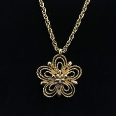 "This daisy pendant and gold chain necklace is gold plated. The rope style chain measures 16 inches and holds a 1.75 inch, open work five petal flower pendant. The back of the pendent is marked,\" MONET c\". It has a nice weight to it and not heavy. The spring clasp is original to the necklace. There is a small metal tag marked,stamped, \"Monet\" with a, \"C\" in a circle on the back. The multiple gold plating is still in excellent condition. This metal necklace is circa 1965 and made by a high end costume jewelry maker of the time, Monet.  The first half of the 20th century was the heyday for well made costume jewelry sold from fine department stores to Woolworth, usually made in Europe or the United States. The manufacture and quality of costume jewelry deteriorated in the latter part of Vintage Metal Necklace With Flower Pendant, Gold Retro Round Pendant Necklace, Gold Retro Round Pendant Jewelry, Retro Gold Jewelry With Adjustable Chain, Retro Gold Round Pendant Jewelry, Retro Brass Pendant Jewelry, Retro Gold-tone Jewelry Gift, Retro Gold-tone Jewelry For Gift, Vintage Necklace With Flower Pendant And Adjustable Chain