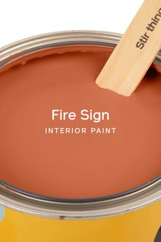 a close up of a paint can with a wooden spatula in it that says fire sign