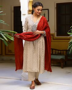 This is a stunning 3-piece set. It comes with a white hand block printed kurta with 3/4th sleeves and a v-neck. The set comes with a pair of printed semi elasticated ankle length palazzo pants and a contrast dupatta to match. Color- Cream & Red Work-Print Work Suit Fabric-Cotton Dupatta Fabric-Mulmul Neck-V Neck Work-Print work with lace detailing Length-Calf Length Care-Hand Wash or Dry Clean Monochrome Kurta Set, White V-neck Festive Kurta, White Anarkali Palazzo Set With Block Print, White Anarkali Kurta With V-neck, White Block Print Straight Kurta Set, Festive White Pant Set With Dupatta, Festive White Kurta With Bandhani Print, Anarkali White Pant Set For Festive Occasions, Festive Bandhani Print V-neck Set