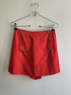 1970s Red Skortwith Brass Buttons 🏷: XS (W-11.5, H-16in, L-14in) | I mean.... it's a skort. I shouldn't have to say more about it. Rayon / Cotton Blend. Button fastens on side. Tiny mark (as pictured) only visible upon extremely close inspection  💌: $45 or get it for $12 via Patreon  *Great vintage condition | All measurements taken flat Red Short Skort With Built-in Shorts, Red Summer Skort With Built-in Shorts, Red Skort With Built-in Shorts, High Waist Red Cotton Skort, Red Cotton Short Length Skort, Red Cotton Short Skort, Red Cotton Short-length Skort, Retro Red Shorts, Red Cotton Skort Of Short Length