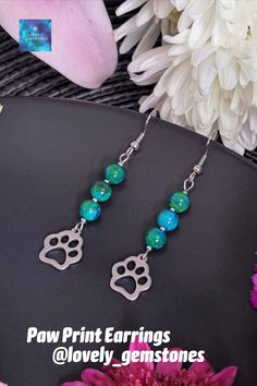 Dainty dangle paw print gemstone earrings, made with 6mm green bluish chrysocolla round beads, and with stainless steel fish hooks and paw print charms. These green- bluish and silver drop earrings, would be a perfect last minute gift for your best friend, dog lover, cat lover, pet parent, vet tech, animal lover.
Please follow us for updates on:
Instagram, Pinterest and Tik Tok @lovely_gemstones Paw Print Earrings, Paw Print Charm, Natural Stone Earrings, Fish Hooks, Earrings Inspiration, Vet Tech