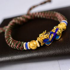 The Pi Xiu bracelet "Wealth and Abundance", carefully hand braided, is adjustable according to the size of your wrist thanks to its sliding thread system. Chic and easy to wear, this 24K gold-plated Pi Xiu protection bracelet will be an original and quality set for your wrist. ABOUT PI XIU This celestial animal is pronounced as “Pixiu” in Chinese. It is a mythical god beast in Chinese mythology, embodied with a dragon head, horse body and qilin’s feet, similar to a lion. Besides that, it has a b Leopard Print Party, Energy Bracelets, Bangles Bracelets, Mens Beaded Bracelets, String Bracelet, Copper Bracelet, Bracelet Clasps, Good Fortune, Metal Bracelets