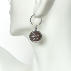 ▪︎ ONE sterling silver round charm with LOVE YOU inscribed on it. ▪︎ Size: 13 x 15 mm ( 17mm with hoop) Weight: 1.3 gm ▪︎ This is a multi functional charm and can be used with neck chains, ear hoops, bracelets, anklets, key chains etc. ▪︎ This pendant is handmade with hypoallergenic sterling silver, and is nickel free. Comes with a 925 mark for authenticity. ▪︎ Please note: Price listed is for ONE charm. This pendant comes WITHOUT the chain, however, you can add a snake neck chain, bracelet chai Inspirational Charms Jewelry For Anniversary, Sterling Silver Dangling Charms Jewelry For Mother's Day, Sterling Silver Dangling Charms As Gift, 925 Stamped Meaningful Jewelry For Anniversary, Mother's Day Sterling Silver Jewelry With Dangling Charms, Hypoallergenic Pendant Charm As A Gift, Hypoallergenic Pendant Charms For Gifts, Metal Charms For Gifts, Silver Round Pendant Charms For Anniversary