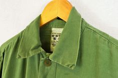 "True vintage Swedish military smock tops from the 1960s-80s, made from a soft cotton with grandad style button down neckline, button cuffs and curved hem. We only have a very small batch of these with no chance of re stock right now, so quantities are limited. - Soft worn in cotton - Loose, comfy fit - Dip hem design - True vintage from the Swedish army - Fabric is 100% cotton SIZING XS - fits chest 34\" Small - fits chest 36\", Medium - fits chest 38\"-40\", Large - fits chest 42\"-44\" XL - f Khaki Cotton Tops With Buttons, Vintage Outerwear With Pockets And Short Sleeves, Green Cotton Utility Top, Green Cotton Outerwear For Daywear, Vintage Cotton Outerwear With Button Closure, Military Style Cotton Tops With Snap Buttons, Utility Cotton Tops With Snap Buttons, Vintage Green Cotton Tops, Utility Cotton Tops With Buttons