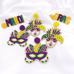 -Mardi Gras Seed Bead Earrings Size Festive Mask L: 2.56" W: 1.97" Festive Face Mask L: 2.75" W: 2.16" Mardi Grass Letter L: 2.46" W: 0.78" Style Options [Letter] [Mask] [Face Mask] Mardi Gras Beaded Earrings, Letter Mask, Mardi Gras Earrings, Mardi Gras Jewelry, Feather Angel Wings, Pearl Drop Earrings Gold, Cat Earrings Studs, Vintage Clip Earrings, Freshwater Pearl Drop Earrings