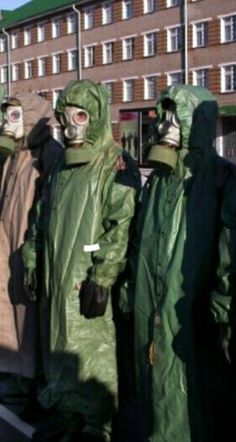 some people in green suits and gas masks