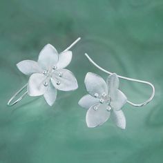 Beautiful silver flower earrings finished in an elegant satin silver. Based on the orange blossom flower these lovely medium sized drops are perfect for freshening up your earring collection. Sterling Silver Size: 25 × 30 mm Size: 25 X 30 mm (drop) All of our sterling silver jewellery comes beautifully packaged in our branded gift box with the option of a handwritten gift note available. We try to process all orders within 24 hours. Our standard delivery method is Royal Mail 48 which normally ta Orange Blossom Flower, Silversmithing Jewelry, Large Drop Earrings, Silver Flower Earrings, Earring Collection, Clay Flowers, Large Earrings, Drop Earring, Blossom Flower