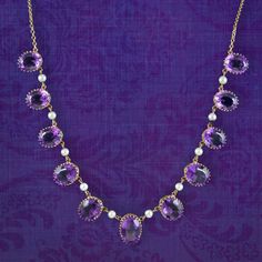 A majestic vintage dropper necklace adorned with eleven oval cut amethyst droppers with bright, white cultured pearls suspended in between. Each amethyst displays a luxurious deep violet hue and graduate in size from 2.2ct to 3.3ct in the middle (approx. 27ct total).  Amethyst is the birthstone of February and is considered a stone of protection, clarity and tranquillity. Its deep violet colouring has been highly esteemed throughout history, adorning regal jewellery all around the world, from an British Crown Jewels, Diamond Chain Necklace, Antique Jewellery Online, Diamond Chain, Antique Necklace, Amethyst Jewelry, Minerals And Gemstones, Wedding Jewellery Necklace, Crown Jewels