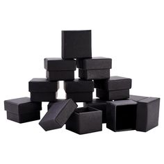 a pile of black boxes sitting next to each other on top of a white surface