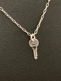 "Teeny tiny key charm is Sterling silver and hangs on a delicate 16 inch sterling silver chain. Love this charming little necklace!            Key Symbolism and Meaning    Keys represent knowledge and success.  The key is also a symbol of freedom and liberation. In a modern romantic notion,  a key necklace may symbolize \"the key to my heart\".   Three keys worn together symbolize the unlocking of the doors to health, wealth and love." Silver Key Necklace, Key Necklaces, The Key To My Heart, Little Necklace, Symbol Of Freedom, Symbols Of Freedom, Silver Key, Key To My Heart, Key Necklace