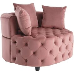 a pink couch with two pillows on it and one pillow is sitting in front of the chair