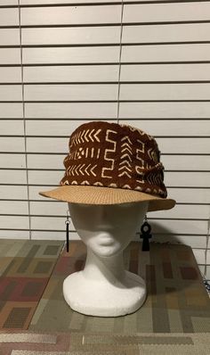 This is a rustic mudcloth fedora that is great for Spring and Summer. The fedora is accented with mudcloths from Mali. This african hat is also accented with trade beads. Don't delay order yours today. Casual Brown Hat For Festival, Brown Casual Festival Hat, Casual Brown Festival Hat, Brown Woven Bucket Hat, Brown Woven Fedora With Short Brim, Brown Wide Brim Festival Hats And Headpieces, Brown Woven Hat With Short Brim, Brown Sun Hat With Short Brim, One Size, Brown Wide Brim Festival Costume Hat