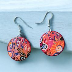 These earrings are one of a kind hand painted paper earrings with cute flower embelishments.  They are coated with quality UV resin. Very light weight!  Earrings come with high quality nickel free hypoallergenic earring hooks. Bohemian Multicolor Floral Print Earrings, Multicolor Floral Print Drop Earrings, Bohemian Multicolor Hand Painted Flower Earrings, Artistic Multicolor Flower Earrings, Colorful Hand-painted Drop Earrings, Colorful Hand Painted Drop Earrings, Handmade Round Resin Flower Earrings, Bohemian Hand Painted Flower Earrings, Artsy Multicolor Flower Earrings