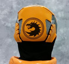 a yellow and black helmet with a dragon on it