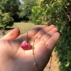 Pink roses are often associated with femininity, grace, gentleness, and elegance.  You can gift this pink rose to a person you really admire. The blooming pink rose is also a symbol of a fresh love that is still in its early phases. This Pink Rose Bud necklace comes with a stylish 925 silver-plated chain. The necklace is made in Italy and it is crafted beautifully.  The dried flower pendant is real and covered in resin. Its size is around 2 cm but may vary since flowers come in different sizes. The chain is approximately long 21 cm. This necklace is also the perfect gift for a Birthday and Valentine's Day.  If you're navigating this listing, it means you're a kind and delicate soul looking for something special for yourself or your beloved ones. Each piece is unique. Please, accept its imp Resin Rose Jewelry, Fresh Love, Forever Flower, Dried Flower Jewelry, Cd Art, Dainty Pendant, Satin Roses, Rose Bud, Rose Pendant