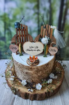 a cake made to look like a boat on a tree stump with flowers around it