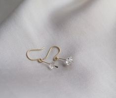 These dainty earrings are a cute way to add a little subtle sparkle to your look! Elegant and understated crystal earrings, but with a raw feel to them. The clean design of these earrings makes them really classy and versatile. Each earring contains a teeny floating Herkimer diamond. Herkimer diamonds are mined from a specific mine from New York State and are known by the double termination (pointy on both sides of the crystal) They are held in a little drop of brass, hammered for a rough textur Delicate Crystal Drop Earrings, Elegant Clear Crystal Earrings For Everyday, Dainty Hypoallergenic Crystal Earrings For Everyday, Delicate Crystal Earrings For Gift, Minimalist Crystal Drop Earrings With Ear Wire, Minimalist Dangle Crystal Earrings, Minimalist Crystal Drop Earrings, Minimalist Nickel Free Drop Crystal Earrings, Minimalist Dangle Crystal Earrings With Ear Wire