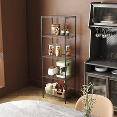 a kitchen with a table and chairs next to a shelf filled with food on top of it