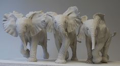 three statues of elephants standing next to each other