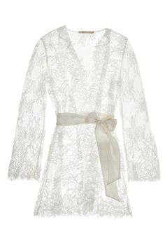 Get ready for your wedding in pure elegance with the Camellia lace robe.Sit and relax while getting pampered the morning of your wedding in this delightful lace robe made of soft Chantilly lace with stunning floral details reminiscent of Camellia flowers. Designed with a scalloped neckline, scallop hem, and long flared sleeves. Finished with a satin belt that hugs your silhouette in all the right places for a confidence boost that's honeymoon-ready.Feel your best in this elegant lace robe on you Feminine Lace Wedding Robe, Elegant Robe For Mother Of The Bride, Feminine Lace With Lace Closure For Wedding, Feminine Lace Robe For Wedding Night, Elegant Lace Wedding Robe, Sheer Lace Wedding Robe, Delicate Lace Robe For Wedding Night, Fitted Lace Sleeves Wedding Robe, Lace Wedding Night Robe With Lace Sleeves