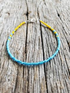 "I reccomend that you measure your ankle and send me the length desired in a note or message. That way I can tailor the length to your personal specifications. If you do not notify me of the size needed, you will get the size selected at checkout with a 2\" extender chain. This anklet is made with light blue, turquoise, and sunshine yellow seed beads. They are strung onto beading wire and finished with a silver color lobster claw clasp and two inch extender chain. Size Options: 8\" adjustable to Bead Anklets, Seed Bead Anklet, Bead Anklet, Beaded Braclets, Womens Ankle Bracelets, Beaded Anklet, Jewelry Beach, Braided Leather Bracelet, Sunshine Yellow