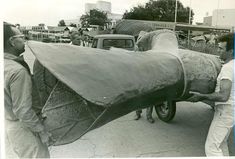 men unloading an airplane from the back of a truck