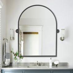 a bathroom with a large mirror and two sinks