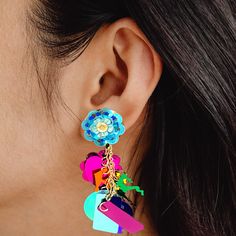 Looking for a fun and fashionable way to add some personality and sparkle to any outfit? Look no further than these fidget-friendly earrings! With so many fun styles to choose from, each pairing has its own unique flair. The designs are created from layers of sequins that move freely from a center point stud, creating a mesmerizing effect that's sure to turn heads. These earrings are perfect for situations where you wouldn't want to risk losing more valuable items. And with their affordable price point, they're a great way for parents to let their little ones add some style without breaking the bank. Whether you're going out dancing or just running errands, these earrings will steal the spotlight and have you feeling carefree as they flash sparkles in all directions. Be noticed wherever yo Trendy Multicolor Drop Plug Earrings, Trendy Multicolor Dangle Plug Earrings, Multicolor Pierced Earrings For Party, Multicolor Flower Drop Earrings For Party, Trendy Multicolor Drop Clip-on Earrings, Trendy Multicolor Flower Earrings For Party, Trendy Multicolor Single Earring, Handmade Multicolor Plug Earrings For Party, Whimsical Drop Earrings For Party