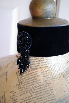 This elegant wide black velvet choker is quite striking in its simplicity. It is hand-beaded with black crystals at the center front, placed in a tear-drop shape along with five black crystals strands that cascade gracefully to adorn the neck. This choker closes at the back of the neck with black satin ribbon, so it comes in One Size. This item is sent packaged securely and sent out with DHL Express, delivered in 2-6 days depending on your location. Please, add your phone number at the Message t Gothic Black Choker For Costume, Gothic Black Choker For Evening, Black Gothic Choker For Evening Wear, Handmade Black Victorian Choker, Vintage Black Choker For Evening, Victorian Goth Jewelry, Wedding Victorian, Different Ear Piercings, Crystal Ball Necklace