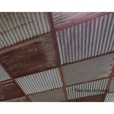 the ceiling is covered with tin sheets and wood planks, which are rusted