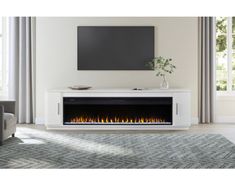 an electric fireplace in the middle of a living room with a television on it's stand