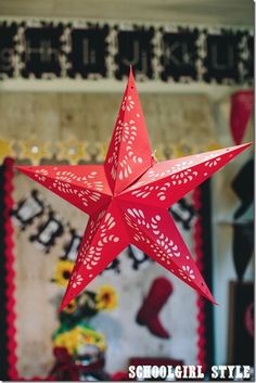 a red paper star hanging from the ceiling