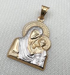 Religione offers a large selection of fine religious jewelry. Every piece of our collection is designed and crafted by talented craftsmen located in the Holy Land using pure gold and genuine diamonds. Religione designs are meant to emphasize the eternal shine that faith in God brings us.  Specification: Gold: 14k solid gold 2.00g Pendant Size: length 1.00inch width 0.8inch Each of our Jewelry pieces: Includes jewelry certificate.  Comes in an elegant jewelry box.  Shipped globally by top carrier Stamped 14k Gold Spiritual Jewelry And Charms, Elegant Crucifix Jewelry With Polished Finish, Gold Spiritual Jewelry And Charms For Wedding, Elegant Polished Crucifix Jewelry, Yellow Gold Spiritual Jewelry For Anniversary, Engraved Yellow Gold Crucifix Jewelry, Luxury White Gold Crucifix Jewelry, Elegant White Gold Crucifix Jewelry, Gold Spiritual Jewelry With Diamond Cut