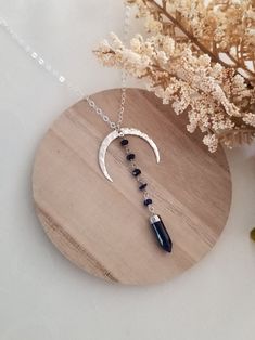 This unique pendant necklace will complete any outfit for day or night. The moon is a symbol of change and regeneration. Lapis Lazuli, the stone of wisdom. Helps us to reconnect with our inner self. Lapis is used to form stronger bonds of friendship and generate inner peace and honesty. A hammed crescent Moon is accented with tiny Lapis Lazuli stones that are wire wrapped together and joined to a Lapis Spike stone. This unique pendant is suspended from shimmering Sterling Silver chain in your ch Spiritual Sterling Silver Crystal Necklace With Moon Charm, Mystical Blue Pendant Necklace, Bohemian Moon Phase Necklace In Sterling Silver, Bohemian Sterling Silver Moon Phase Necklace, Mystical Sterling Silver Crystal Necklace With Moon Charm, Bohemian Sterling Silver Moon Charm Necklace, Bohemian Sterling Silver Necklace With Moon Charm, Spiritual Sterling Silver Moon Phase Necklace, Healing Sterling Silver Moon Necklace