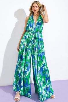 A printed woven jumpsuit featuring V halter neckline, sleeveless, self sash tie, wide leg, bare back with neck tieDetails:Self: 97% Polyester 3% SpandexLining : 100% Polyester Size & Fit- Model is 5`8" And Wearing Size Small- Measurements Taken From Size Small- Approx. Length: 63" Spring Halter Neck Jumpsuit With Tie Back, Green Wide-leg Jumpsuits And Rompers For Spring, Green Wide Leg Jumpsuits And Rompers For Spring, Green Halter Neck Jumpsuit For Beach, Chic Floral Print Halter Neck Jumpsuit, Blue Sleeveless Tie Back Jumpsuit, Chic Halter Neck Jumpsuit With Floral Print, Blue Sleeveless Jumpsuit With Tie Waist, Sleeveless Blue Jumpsuit With Tie Waist