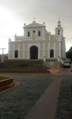 an old church in the middle of a road