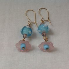 Lampwork glass flower earrings. Art glass and vintage lucite flower earrings on gold tone ear wires Dangle earrings for pierced ears Gold tone ear wires  Pink lucite flower petal with blue art glass and small Czech beads Roughly 1inch drop A great accessory for wedding guest and other great occassions Bohemian bride, vintage bride Czech Glass Dangle Flower Earrings With Ear Wire, Vintage Flower Charm Dangle Earrings, Czech Glass Flower Earrings With Flower Charm, Handmade Czech Glass Flower Dangle Earrings, Whimsical Czech Glass Drop Earrings, Handmade Czech Glass Flower Earrings In Vintage Style, Handmade Czech Glass Vintage Flower Earrings, Handmade Vintage Czech Glass Flower Earrings, Vintage Adjustable Dangle Flower Earrings