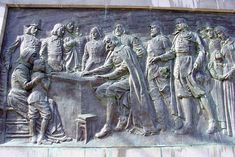 this is an image of a monument with people in uniform and holding their hands together